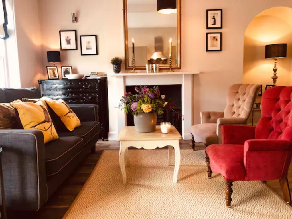 a living room with a couch and a table at Old Beams - Central Bakewell Stylish Duplex for 5 in Bakewell