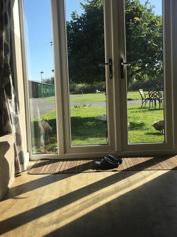 an open door with a view of a field at Formby Point in Liverpool