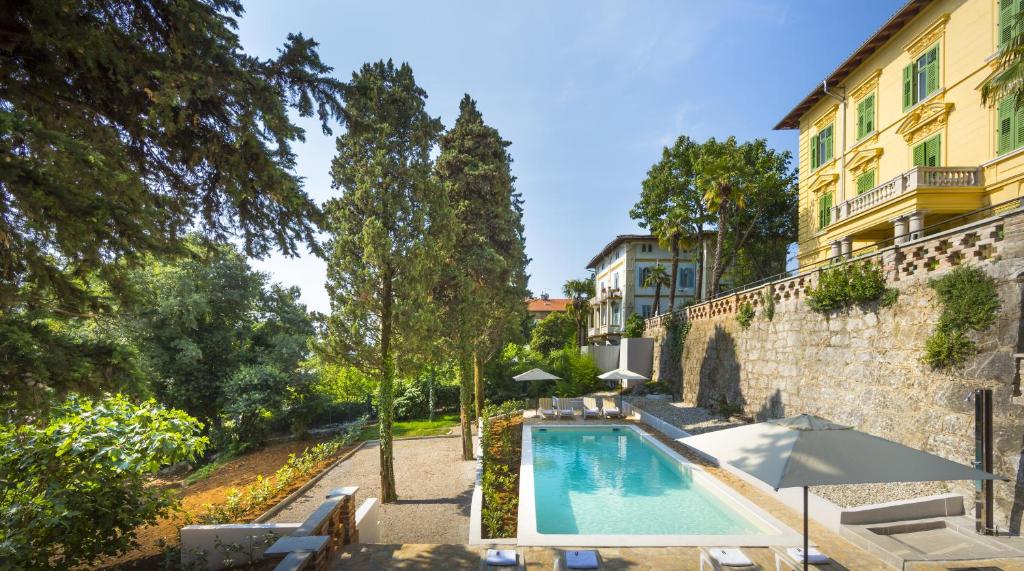 a swimming pool in front of a building at Apartments Atlanta - Liburnia in Lovran