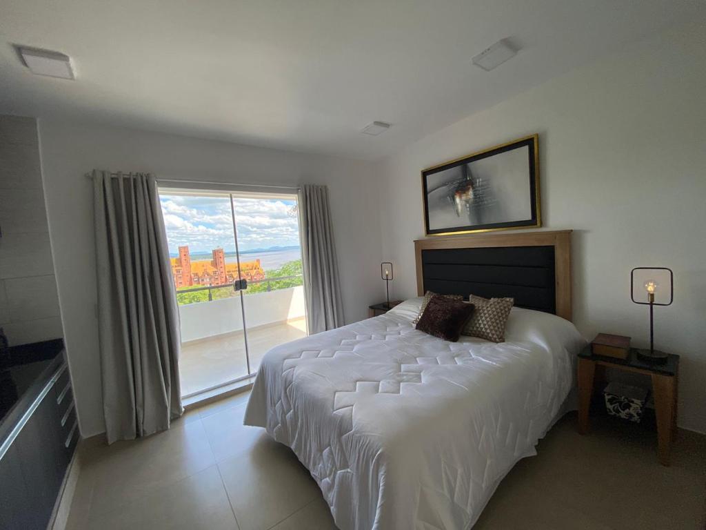 a bedroom with a large bed and a large window at Departamento céntrico con la mejor vista. San Bernardino in San Bernardino