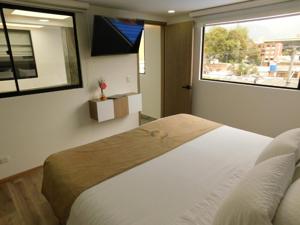 Postel nebo postele na pokoji v ubytování HOTEL MX BOGOTA
