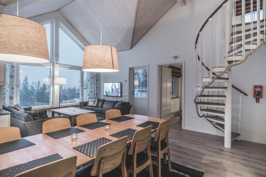 a dining room and living room with a table and chairs at Trillevallens Högfjällshotell & Lägenheter in Trillevallen