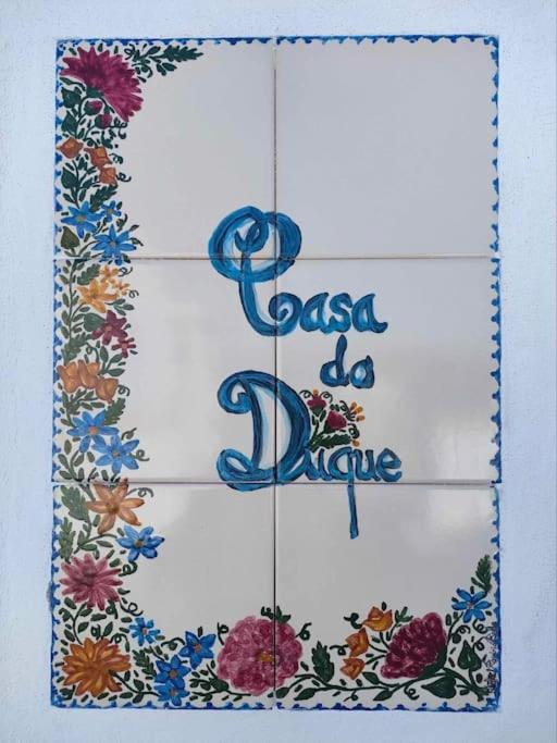 a sign for a dance with a floral pattern at Casa do Duque in Arneiro