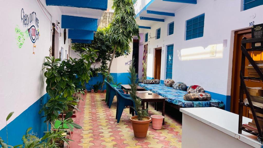 a room with tables and potted plants in a building at Mayur Guest House in Pushkar