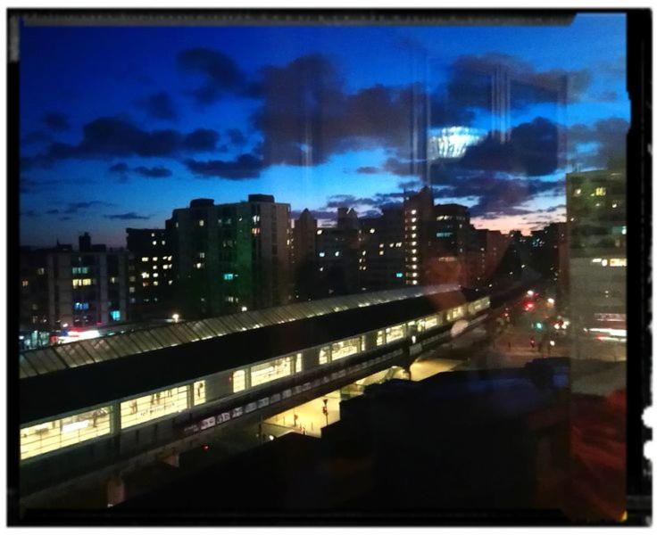 a train station in a city at night at Room with a view in Berlin