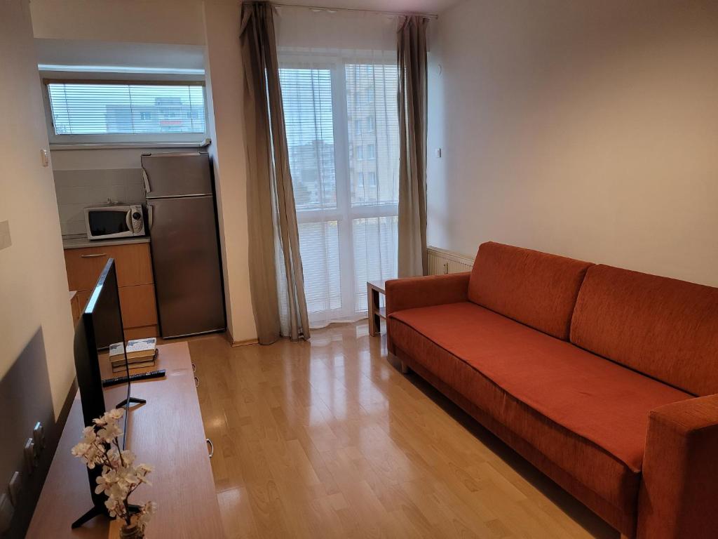 a living room with a couch and a kitchen at Apartmán Neva Trnava in Trnava