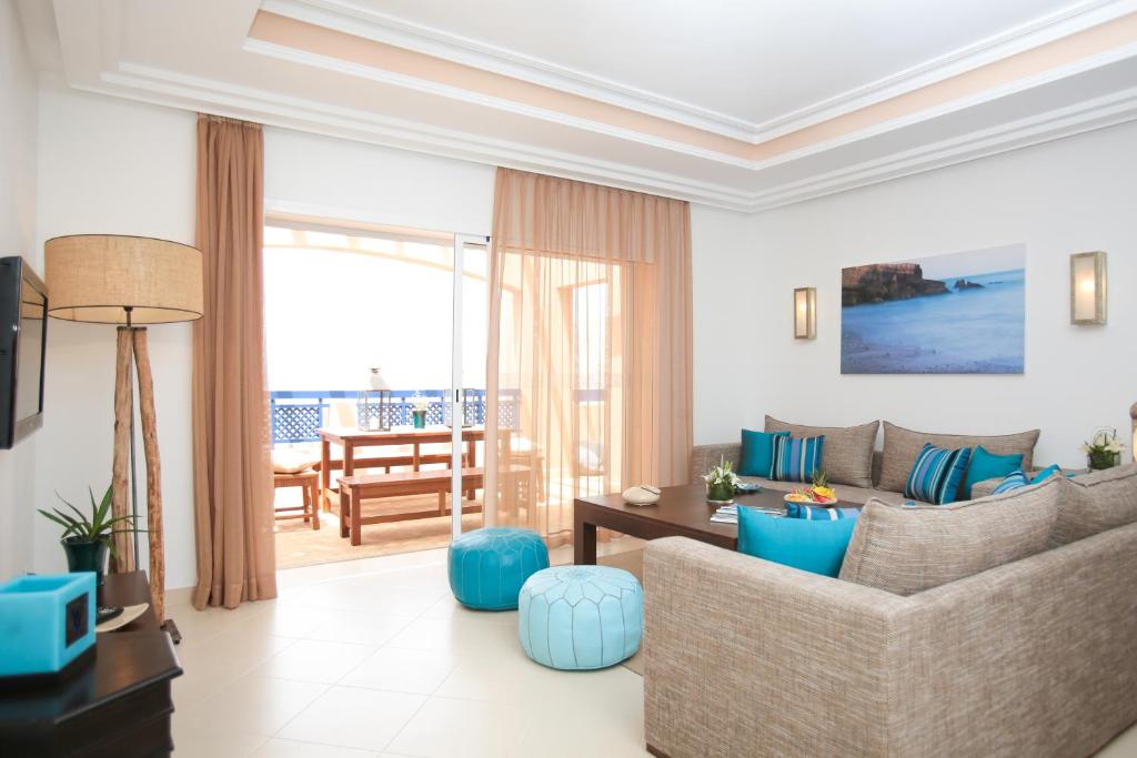 a living room with a couch and a table at Apparthotel Eden Beach in Taghazout