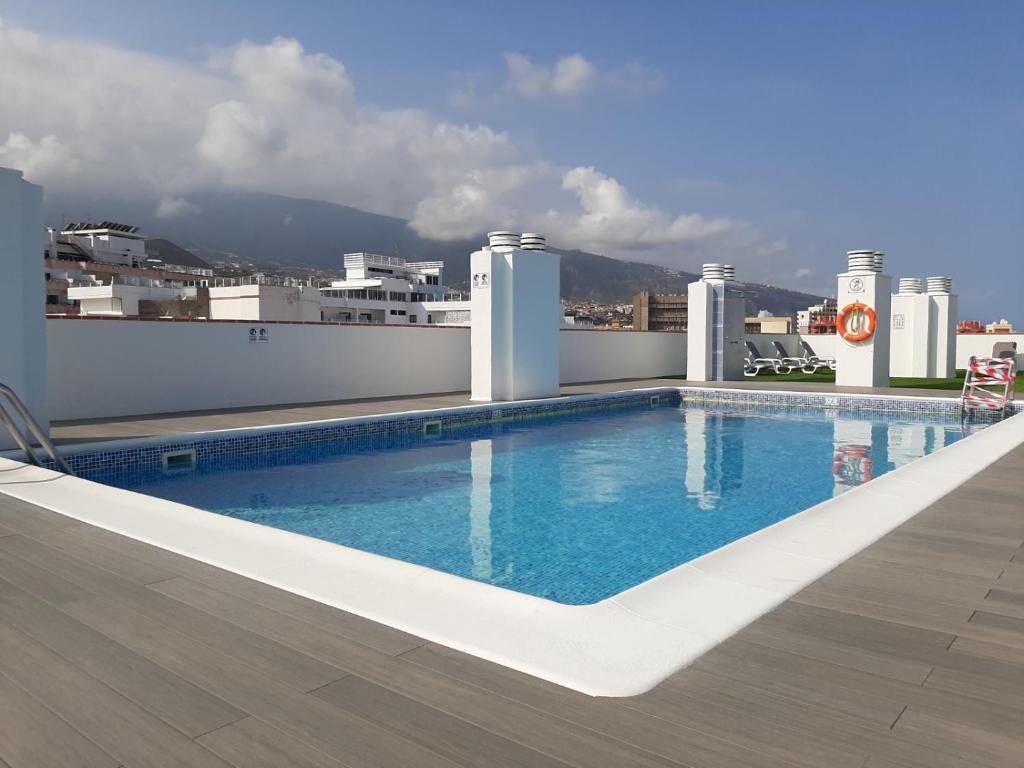 a swimming pool on the roof of a building at Appartement Girasol Puerto de la Cruz, plaza Charco in Puerto de la Cruz