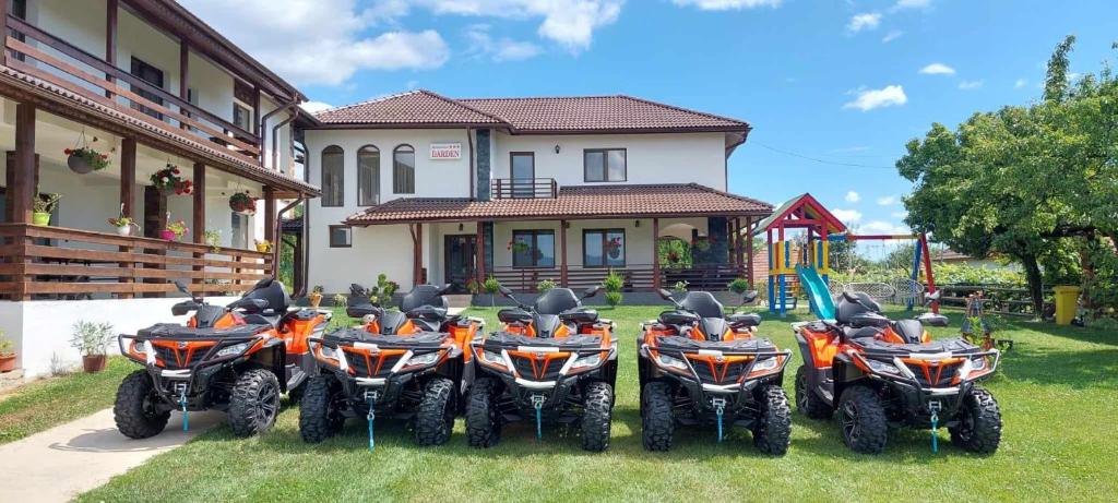 a group of motorcycles parked in front of a house at Agropensiunea DarDen in Baia de Fier