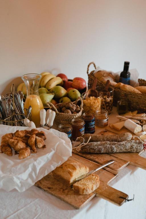 a table topped with lots of different types of food at Hotel-Masia Can Farrés in El Bruc