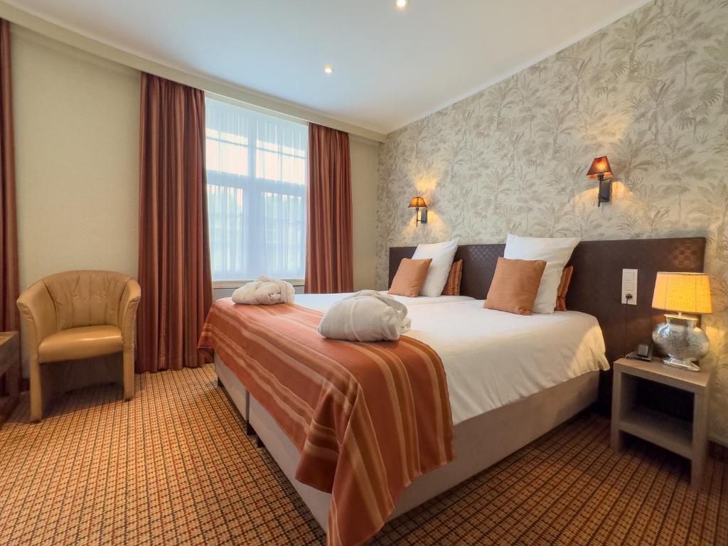 Postel nebo postele na pokoji v ubytování Hotel Pavillon Du Zoute
