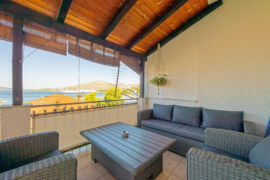 a patio with a couch and a table on a balcony at Apartments Alen in Trogir
