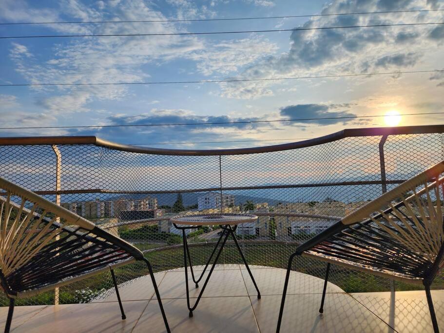 a balcony with two chairs and a table and a view of the ocean at Alojamiento, Penthouse, Dúplex, Spa in La Mesa