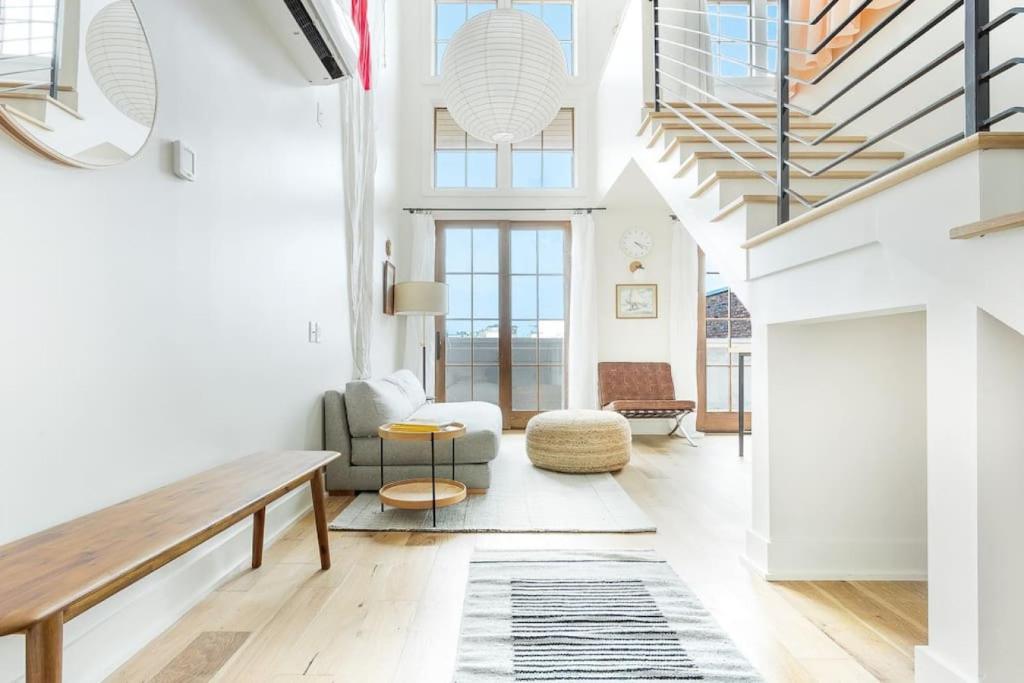 a living room with a couch and a table at Top Floor Loft With Terrace in Savannah