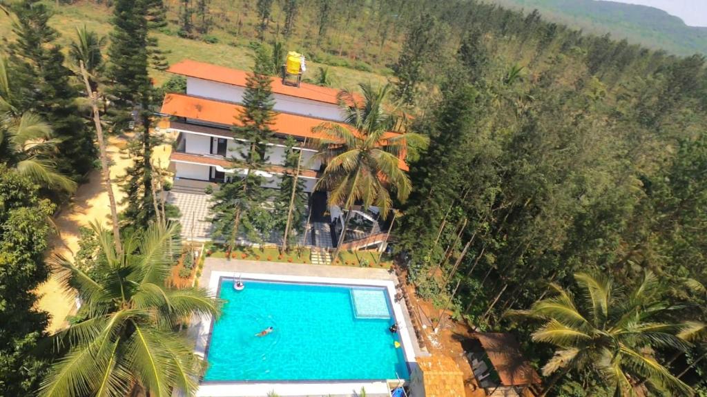 - une vue aérienne sur un complexe avec une piscine dans l'établissement Mazra Retreat, Coorg Kushālnagar, à Kushalanagar