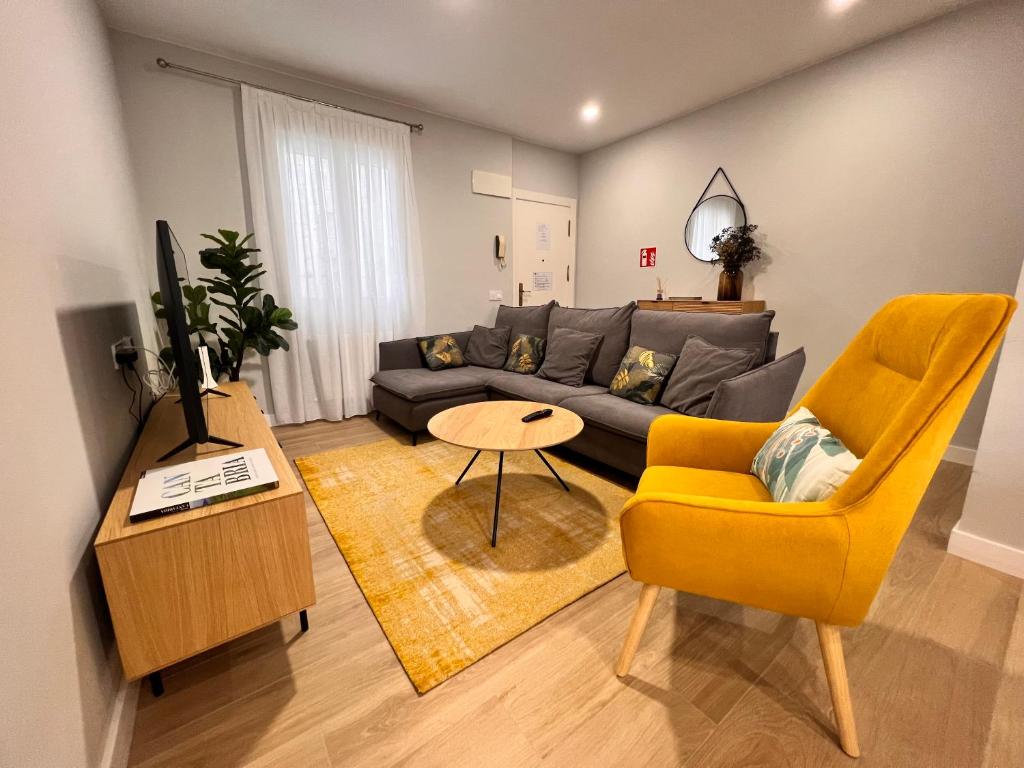 a living room with a couch and a table at Apartamento reformado centro de Santander in Santander