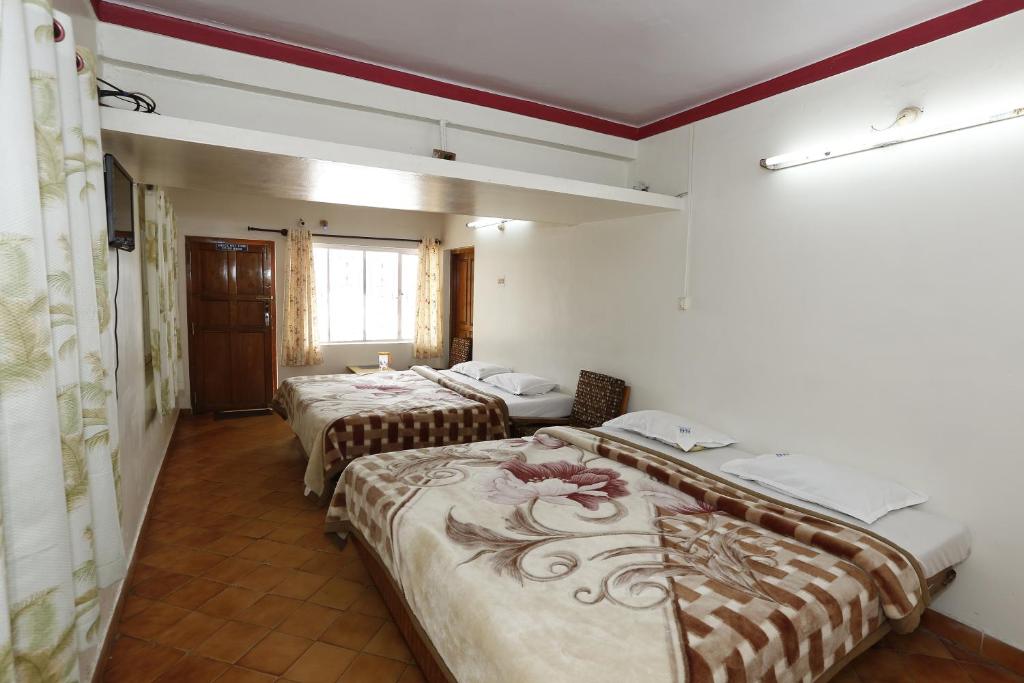 Postel nebo postele na pokoji v ubytování Hotel Sri Balaji