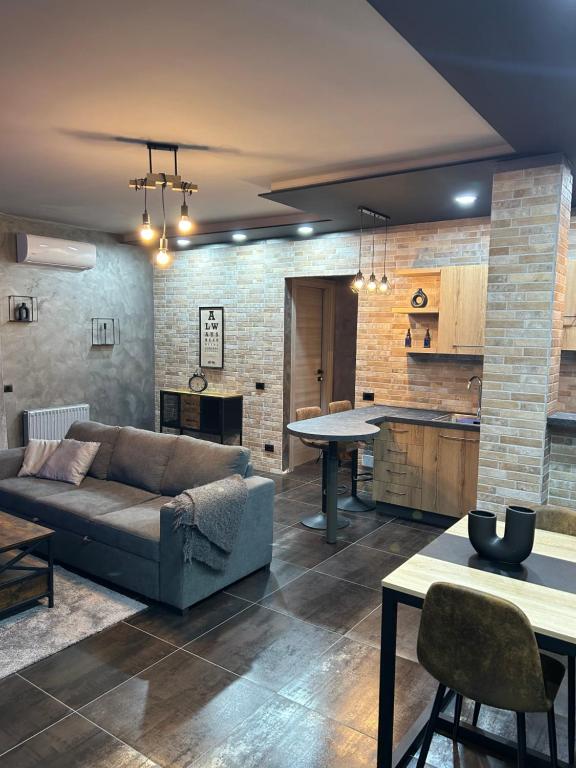 a living room with a couch and a table at THE ROOFTOP in Reggio Emilia