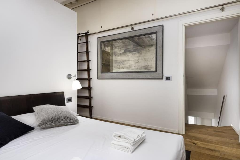 a bedroom with a bed and a picture on the wall at UNYCA - Residenza San Lorenzo in Florence