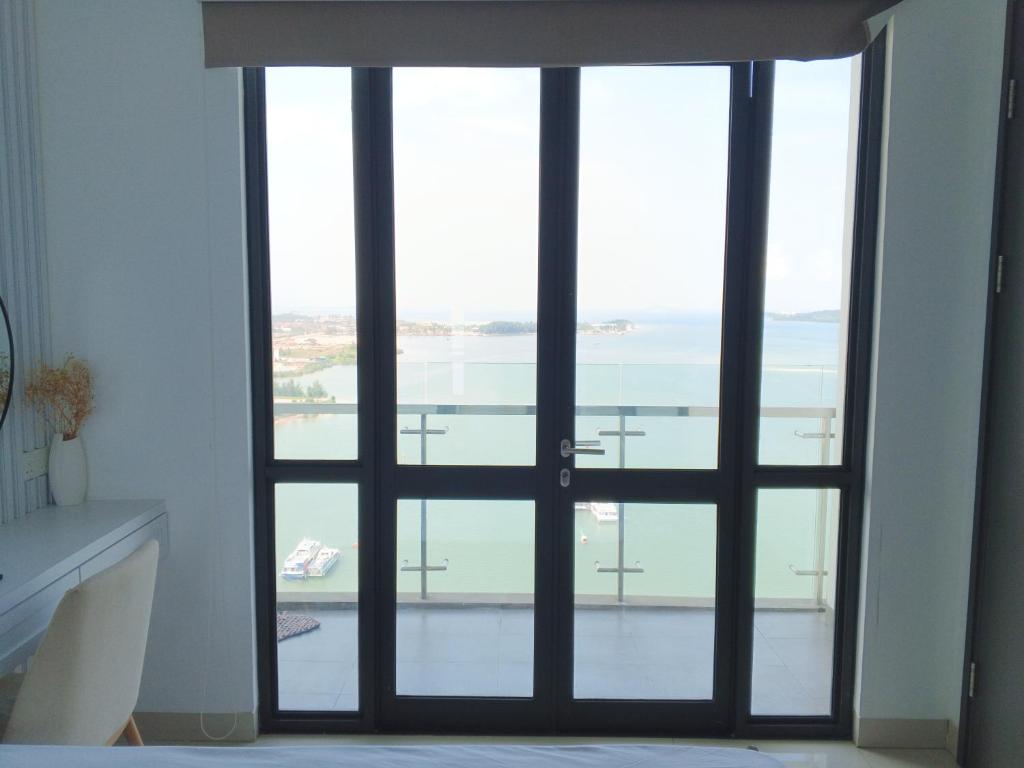an open door with a view of the water at Peaceful Sea view Cozy APT at Batam Center - By MESA in Batam Center