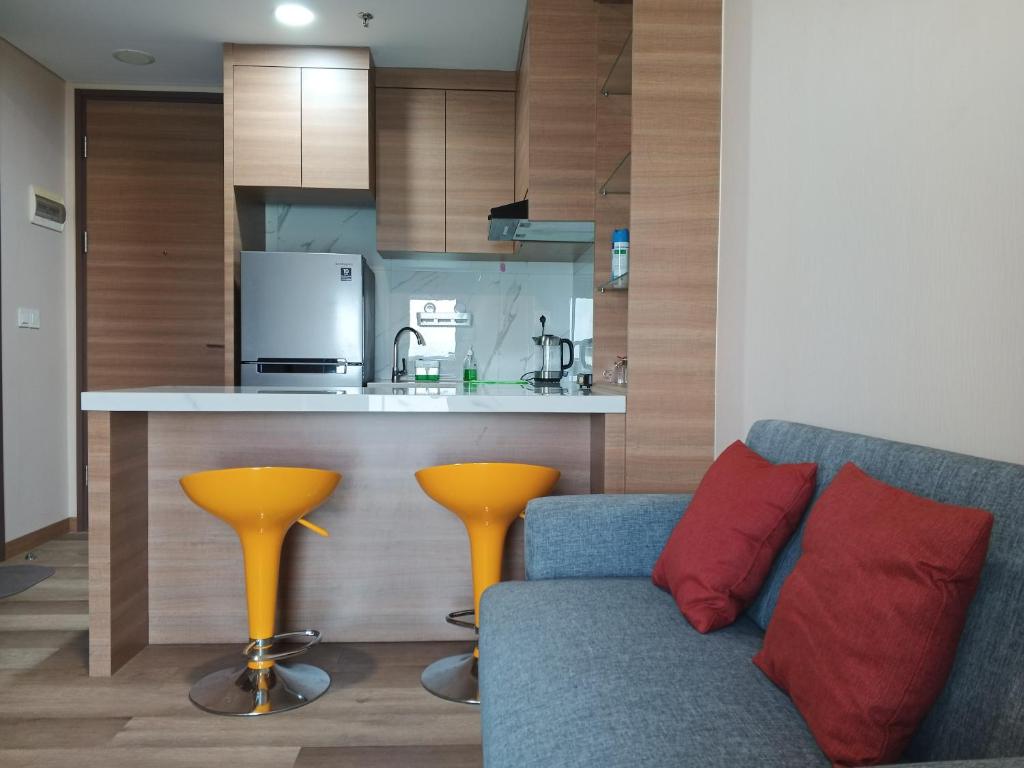 a living room with a couch and a kitchen at Peaceful Sea view Cozy APT at Batam Center - By MESA in Batam Center