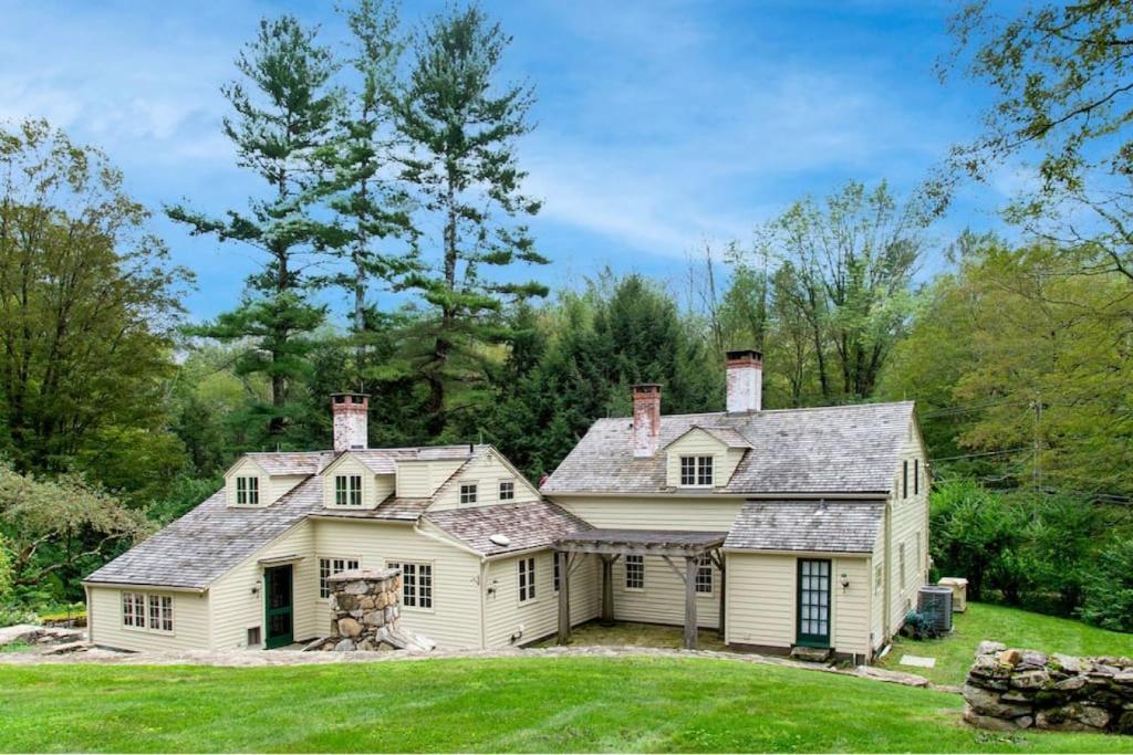 a large white house with a roof at Historic Estate - 5 min to Mohawk Mt Ski Resort 
