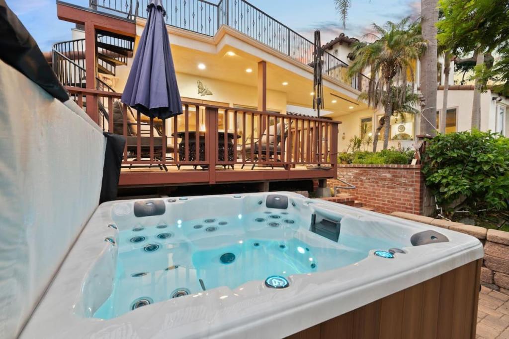 a hot tub on a patio with a house at Casa Solana water views family friendly in Solana Beach