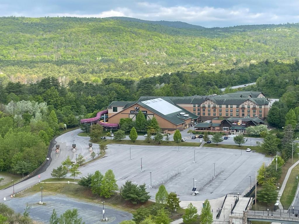 an aerial view of a building with a large parking lot at Six Flags Great Escape Lodge & Indoor Waterpark in Queensbury