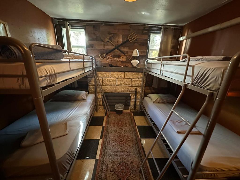 a room with three bunk beds and a fireplace at OQP Vacations Cottage in Miami
