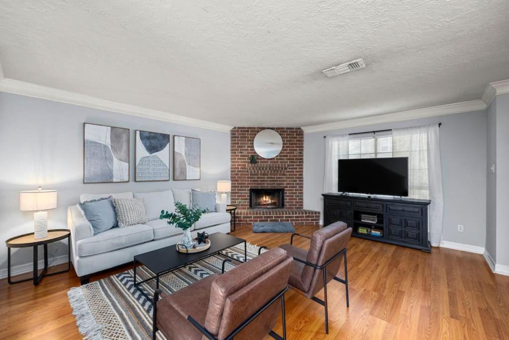 a living room with a couch and a fireplace at Montrose 2BR Sleeps 10 Walkable Gated Parking in Houston