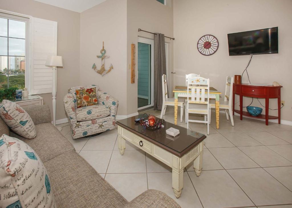 a living room with a couch and a table at Grand Caribbean 420 by ALBVR - Great condo and views that won't break the bank. Must see! in Orange Beach