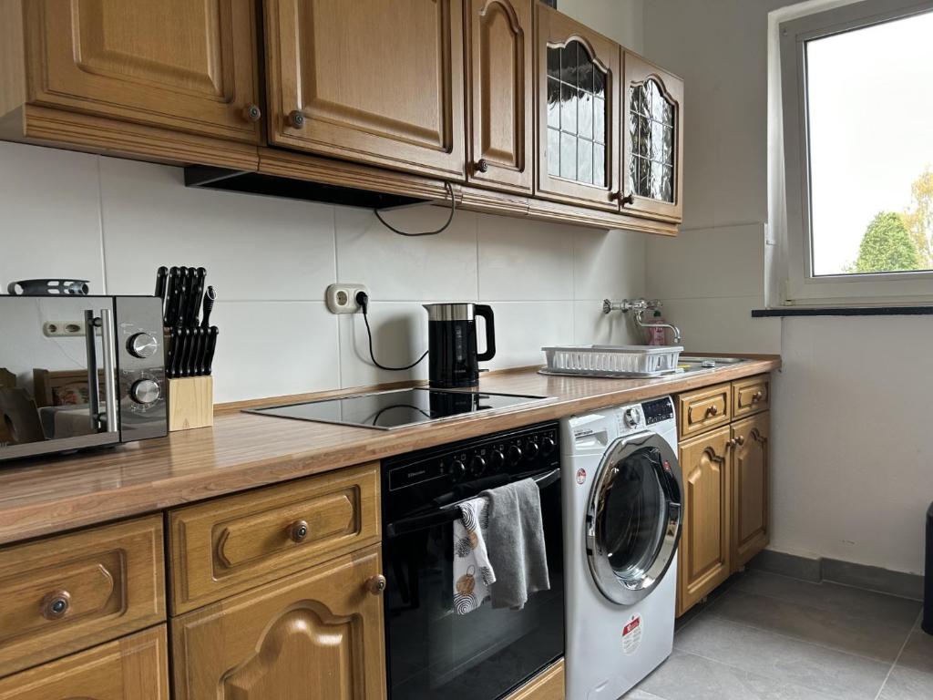 a kitchen with a dishwasher and a stove top oven at Central Service Apartment in Recklinghausen