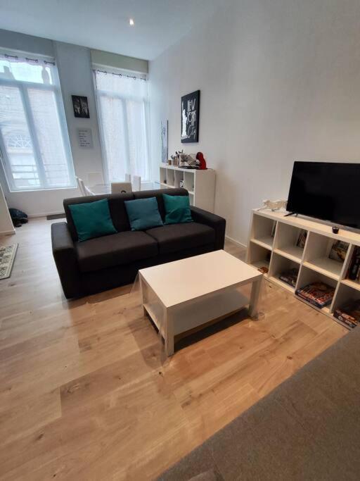 a living room with a couch and a coffee table at Grand volume calme centre-ville Tan1 in Cambrai