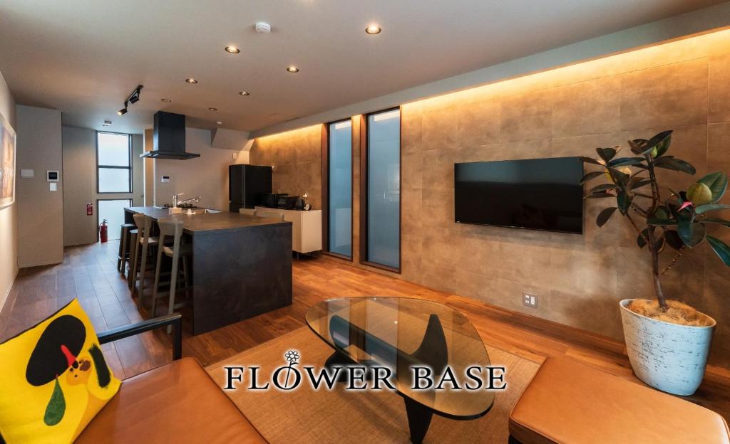 a kitchen and living room with a table and a tv at Flower Base TSUBAKI - Vacation STAY 59155v in Fukuoka