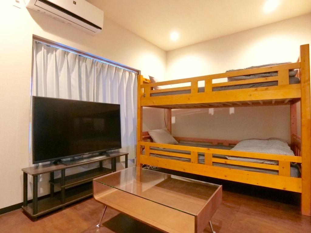 a living room with two bunk beds and a flat screen tv at futaba heights - Vacation STAY 15533 in Tokyo
