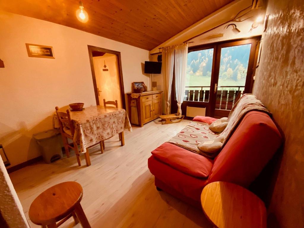 un salon avec un canapé et une table dans l'établissement Appartement cosy 4 pers. avec balcon et vue à La Clusaz - FR-1-459-218, à La Clusaz