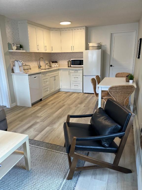 a kitchen with a black chair and a table at Mountain View Bed & Breakfast in Banff