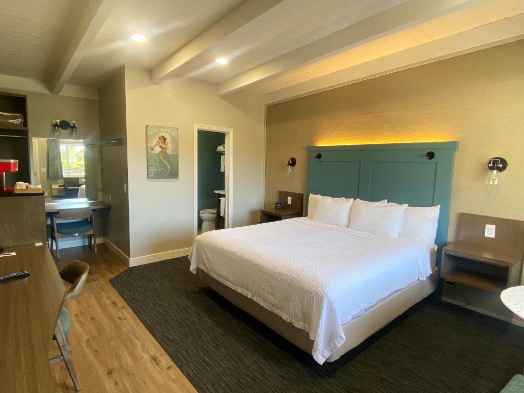 a bedroom with a large bed and a bathroom at Castle Inn in Cambria