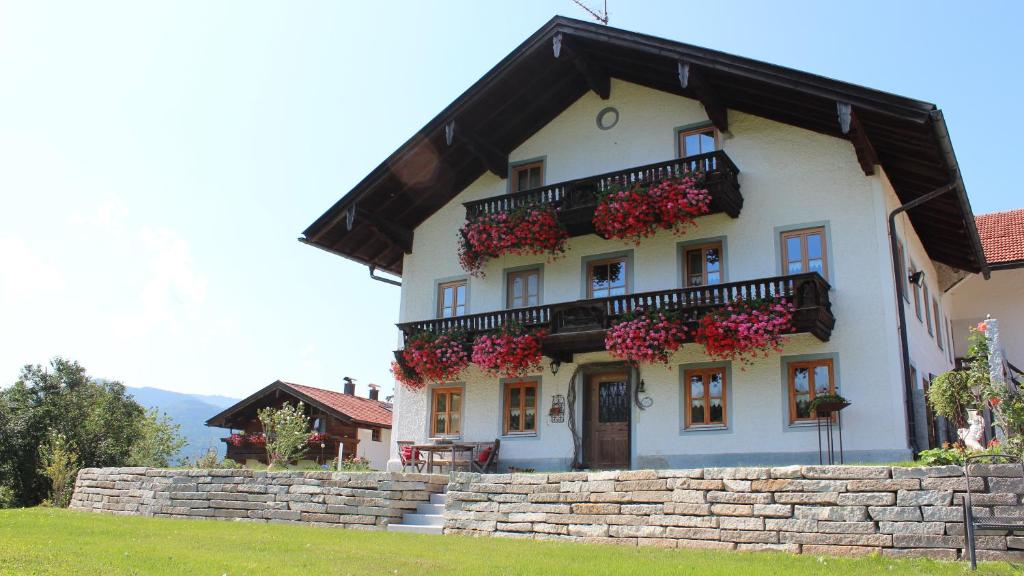 a large white house with flower boxes on it at Hochgallinger Hof - Der Reiterhof für Groß und Klein in Siegsdorf