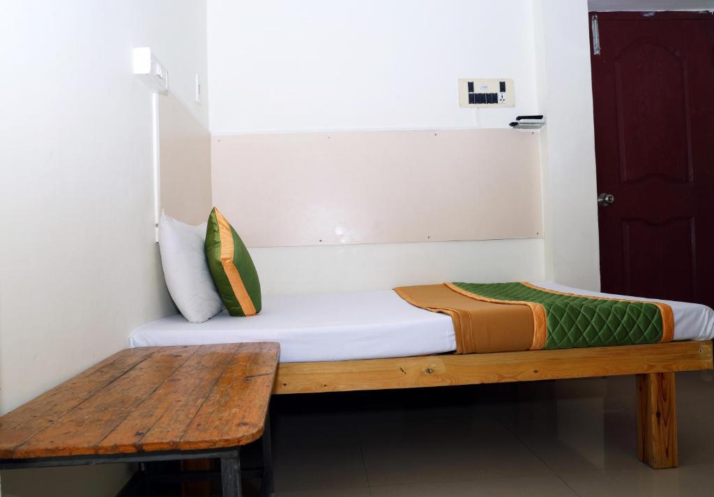 Postel nebo postele na pokoji v ubytování Royal Green Accommodation Chennai Airport