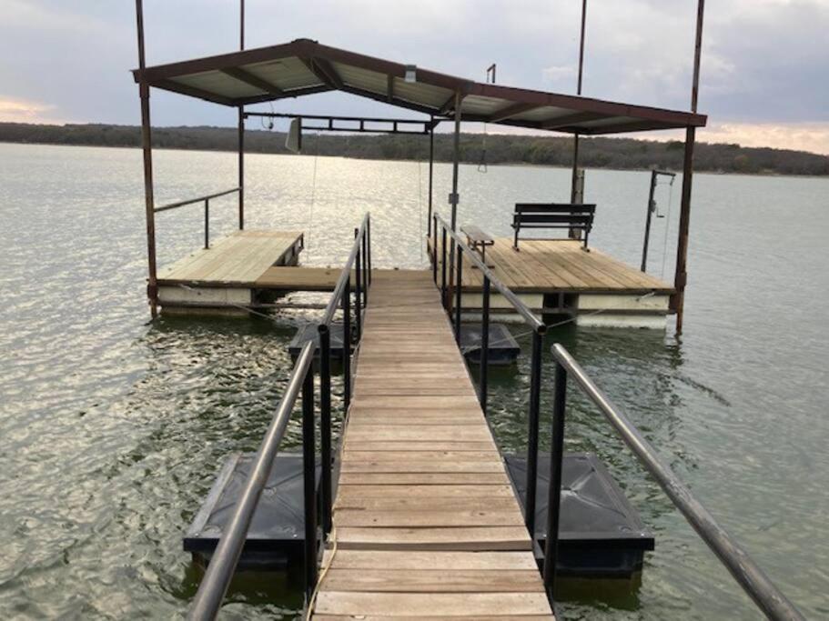 a dock on a lake with a bench on it at Lobo Lake Cabin in Cisco