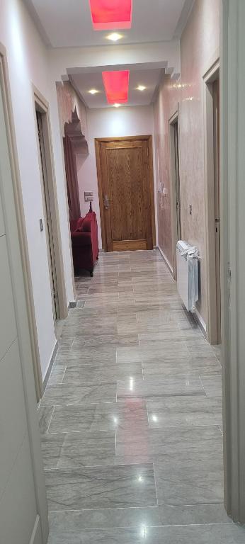 a hallway with a door and a tile floor at Oscar in Ariana