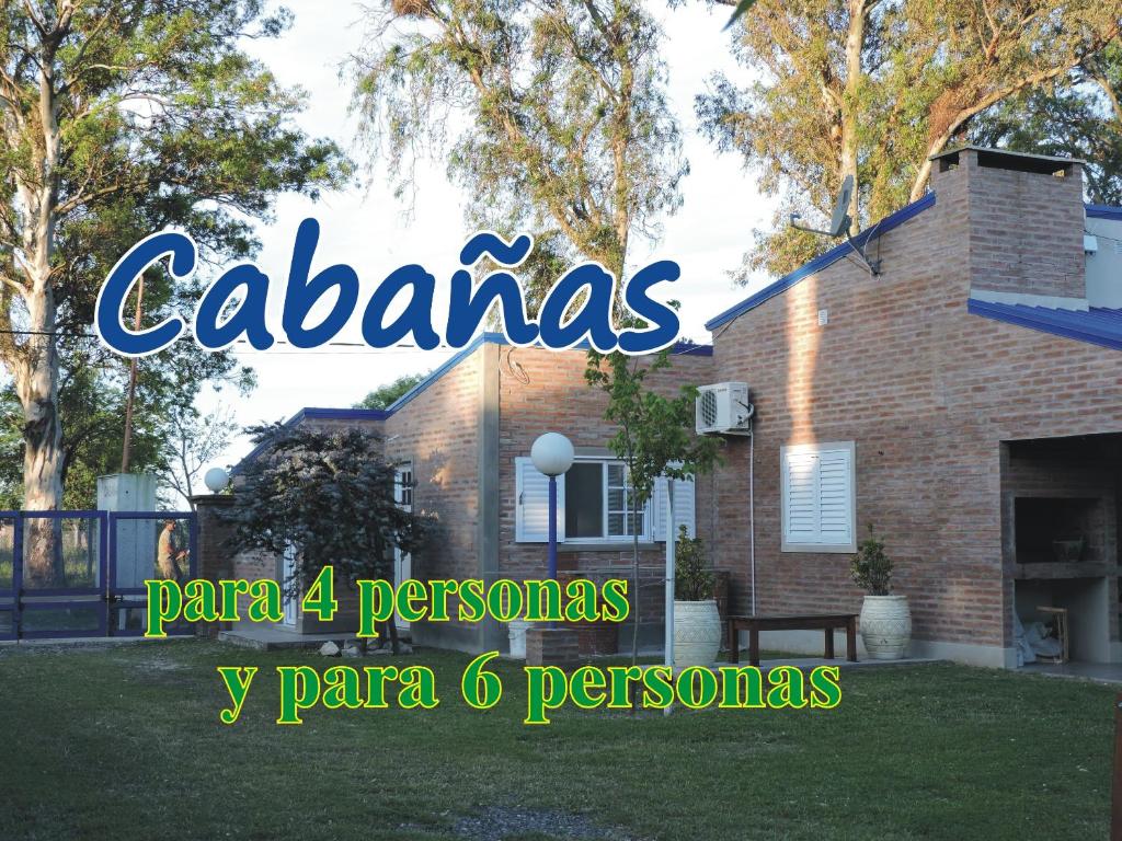 a house with a sign that reads cazares at Cabañas Costa Azul in Sauce Viejo