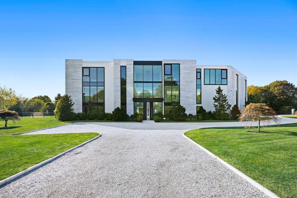 a large white building with a driveway at Exquisite Hamptons Mansion Retreat in Water Mill