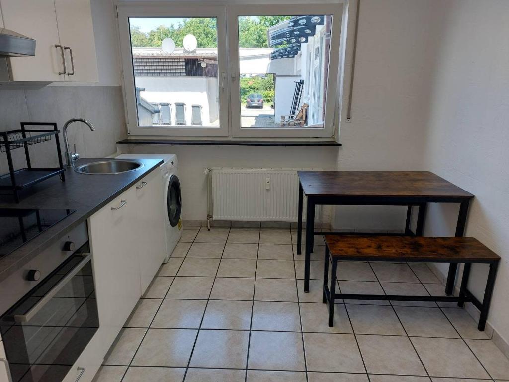 a kitchen with a table and a table and a sink at L8 Street - Leipziger Straße in Kaiserslautern