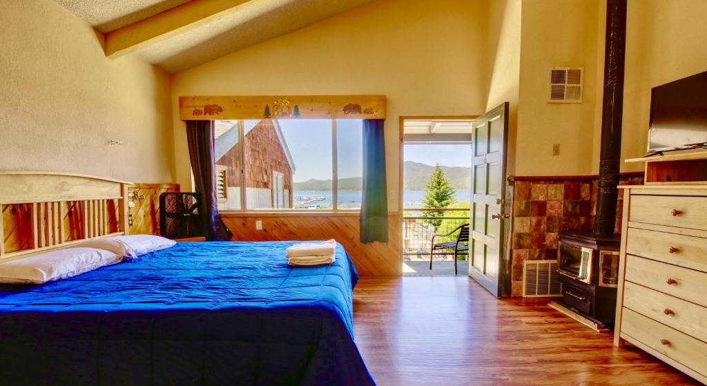 a bedroom with a bed and a large window at Lakefront Escape in Big Bear Lake