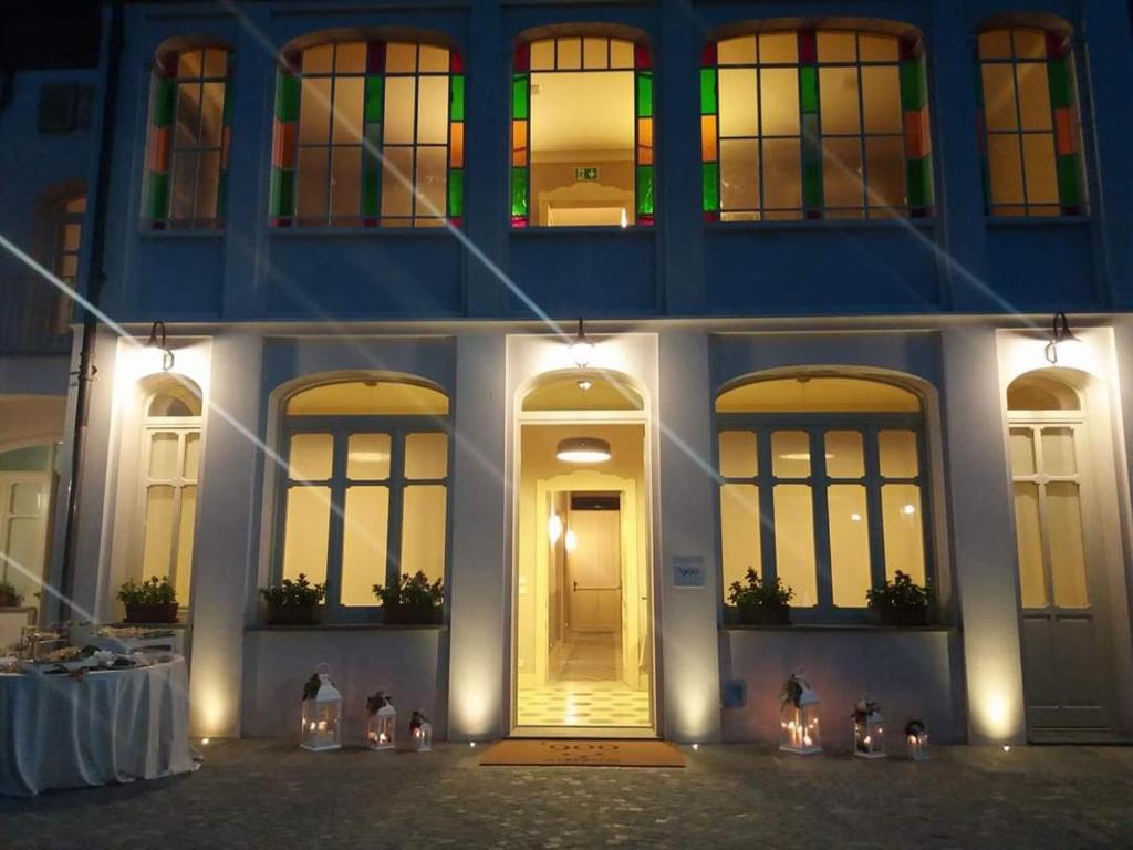 a building with lit up windows and a yellow door at Albergo '900 in Quattordio