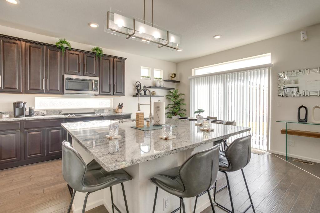 a kitchen with a large island in the middle of a room at Aurora Vacation Rental about 18 Mi to Downtown Denver! in Aurora