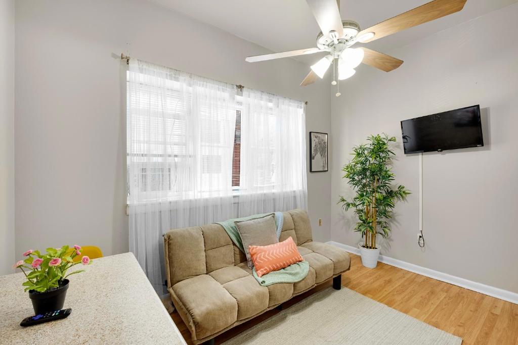 a living room with a couch and a ceiling fan at Boutique 1br With Charm And Style in Philadelphia