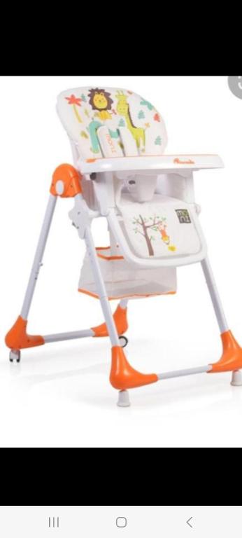 an orange and white high chair with a baby seat at Belgrade Waterfront W in Sajmište